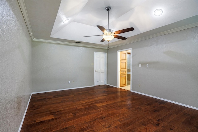 unfurnished room with dark wood-type flooring, ornamental molding, and baseboards