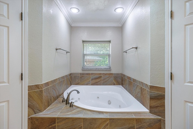 full bathroom featuring ornamental molding, a textured wall, and a tub with jets