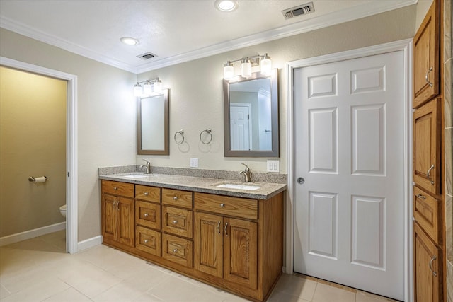 full bathroom featuring double vanity, ornamental molding, a sink, and visible vents