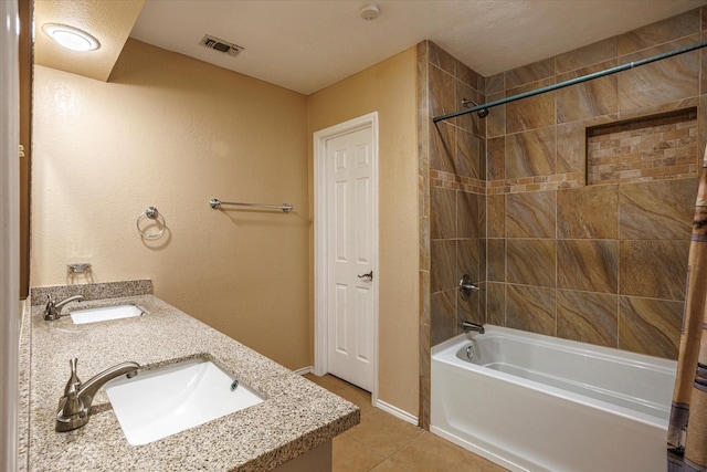 full bath featuring shower / bathtub combination with curtain, a sink, visible vents, and tile patterned floors