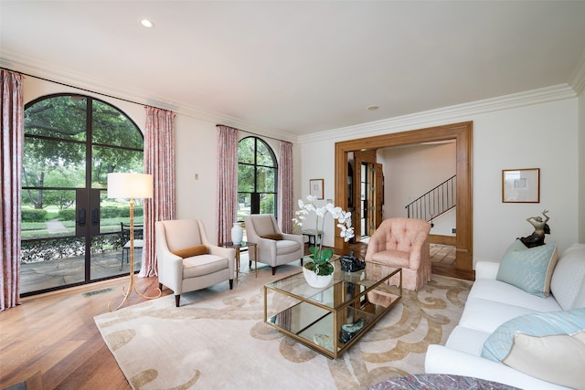 living area featuring crown molding, recessed lighting, visible vents, stairway, and light wood-style floors