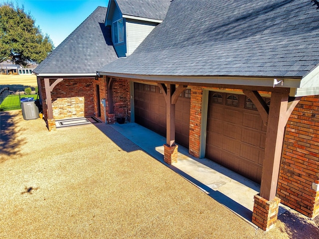 garage with driveway and fence