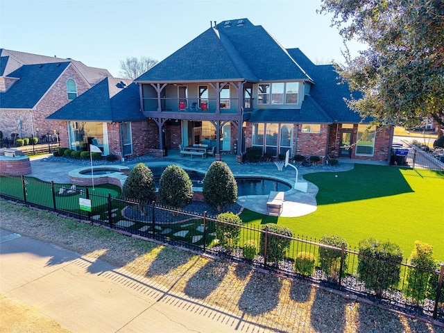 rear view of house with a fenced in pool, a lawn, a balcony, an in ground hot tub, and fence private yard