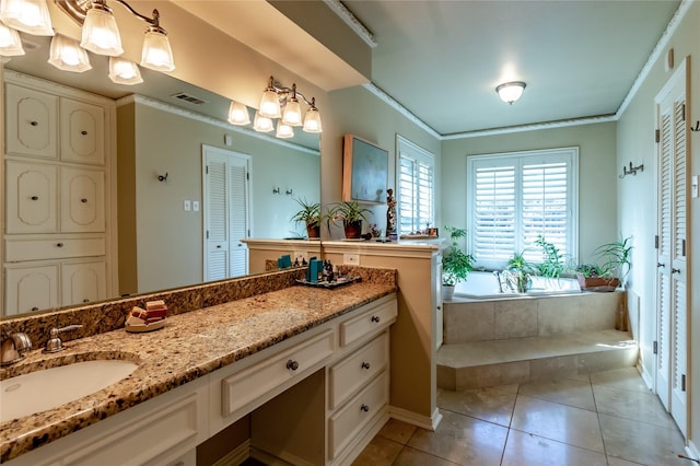 bathroom with tile patterned flooring, a garden tub, vanity, ornamental molding, and a closet