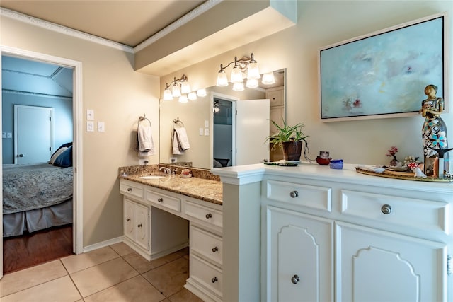 bathroom with ornamental molding, tile patterned flooring, vanity, and ensuite bathroom