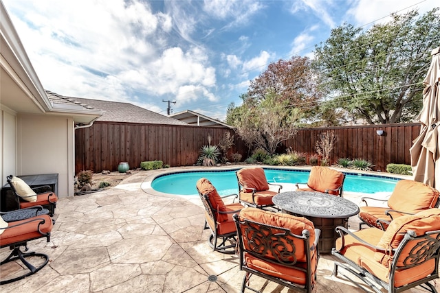 view of swimming pool with a fenced in pool, a fenced backyard, and a patio