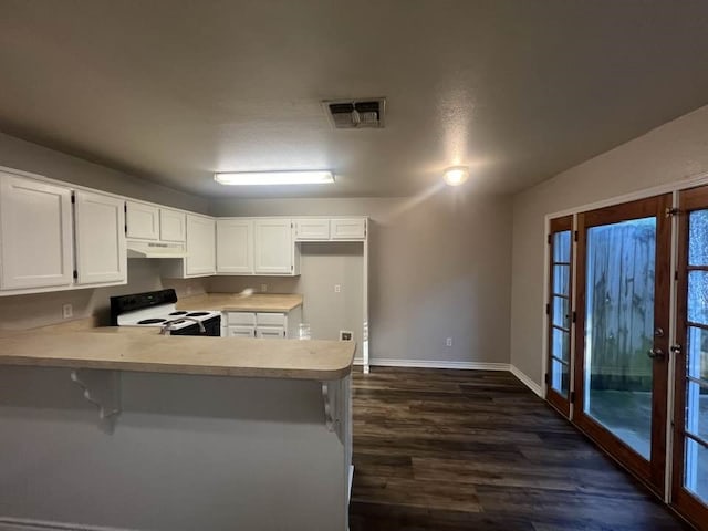 kitchen featuring range with electric stovetop, light countertops, white cabinets, a peninsula, and under cabinet range hood