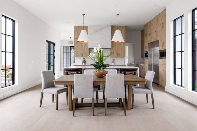 dining area featuring light wood-style flooring