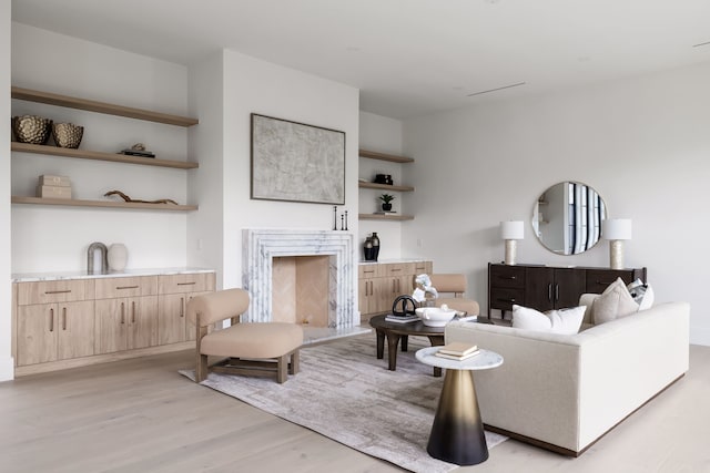 living area with a fireplace and light wood-style flooring