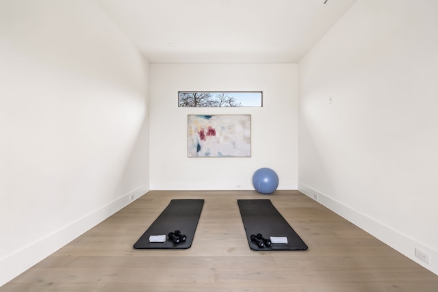 workout room with wood finished floors and baseboards