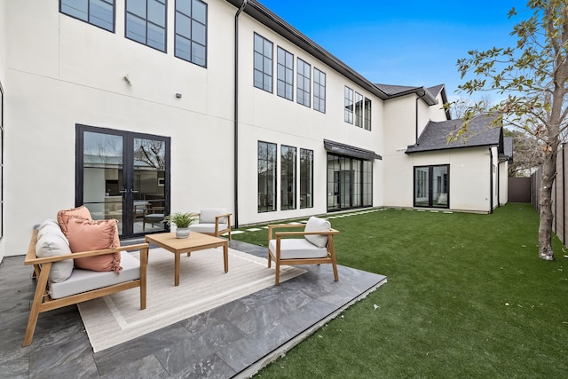 rear view of house featuring french doors, stucco siding, a lawn, an outdoor hangout area, and fence