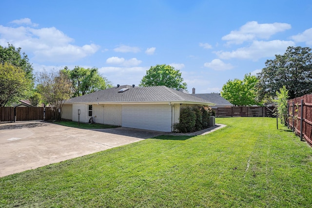 view of side of home with a garage, a fenced backyard, a lawn, brick siding, and concrete driveway