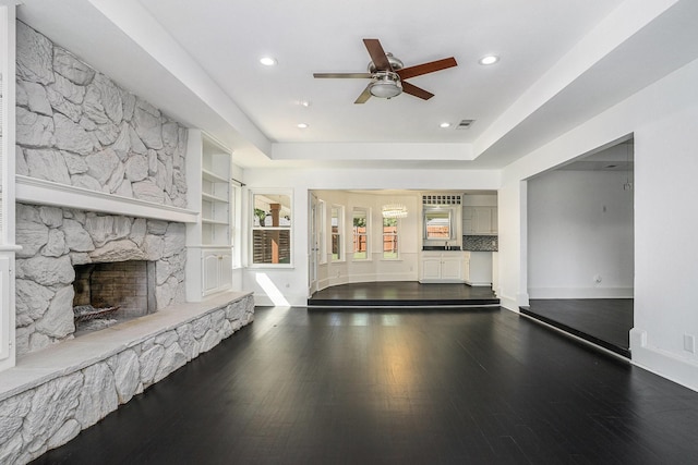 recreation room featuring dark wood-type flooring, a ceiling fan, visible vents, a stone fireplace, and recessed lighting