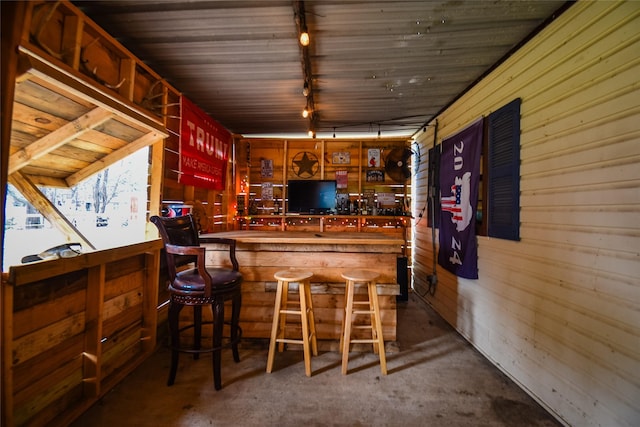 bar featuring track lighting and a bar