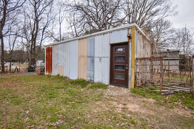 view of pole building featuring a yard and fence