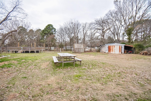 view of yard with fence and an outdoor structure