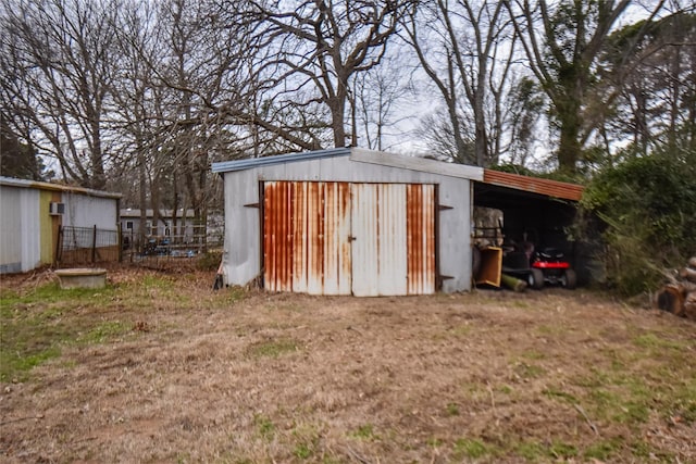 view of outbuilding featuring fence and an outdoor structure