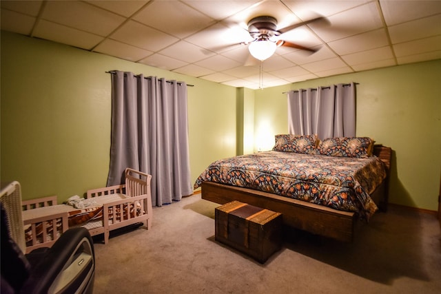 bedroom featuring ceiling fan, a paneled ceiling, and light colored carpet