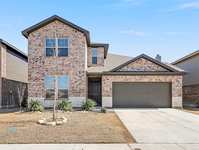 traditional-style house with a garage, driveway, brick siding, and stone siding