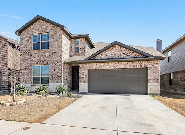 traditional home with driveway, brick siding, and an attached garage