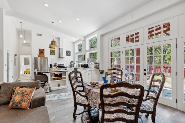 dining space featuring high vaulted ceiling, recessed lighting, french doors, and visible vents