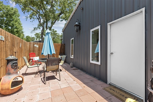 view of patio with outdoor dining area and a fenced backyard