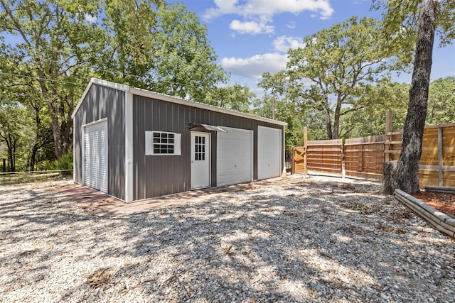 view of outdoor structure featuring an outbuilding and fence