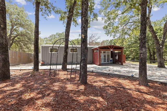 exterior space featuring french doors and fence