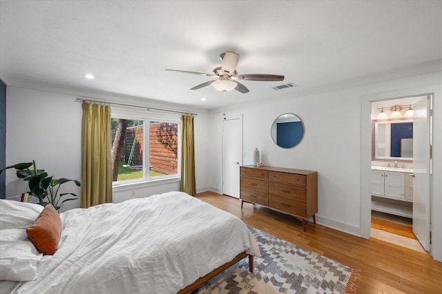 bedroom featuring recessed lighting, a sink, visible vents, baseboards, and light wood-style floors