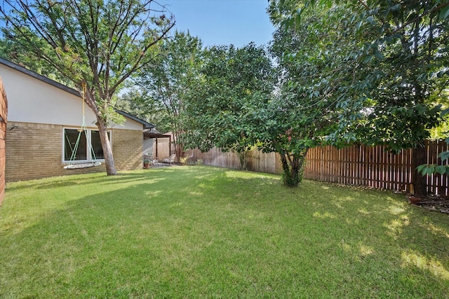 view of yard with a fenced backyard