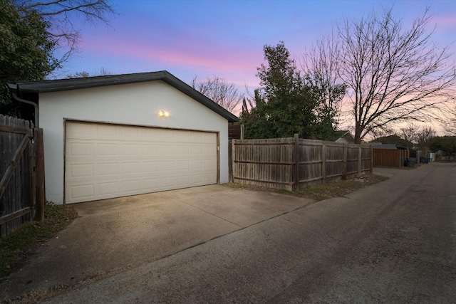 detached garage featuring fence