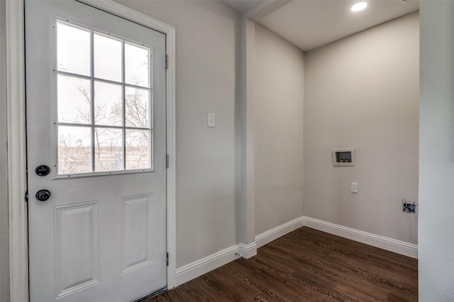 doorway with dark wood-type flooring and baseboards