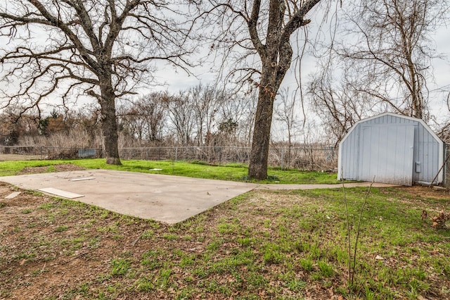 view of yard with basketball hoop and fence