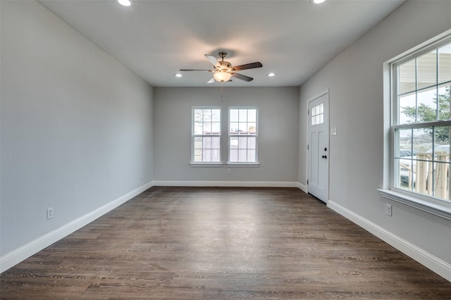 interior space with dark wood-style flooring, recessed lighting, a ceiling fan, and baseboards