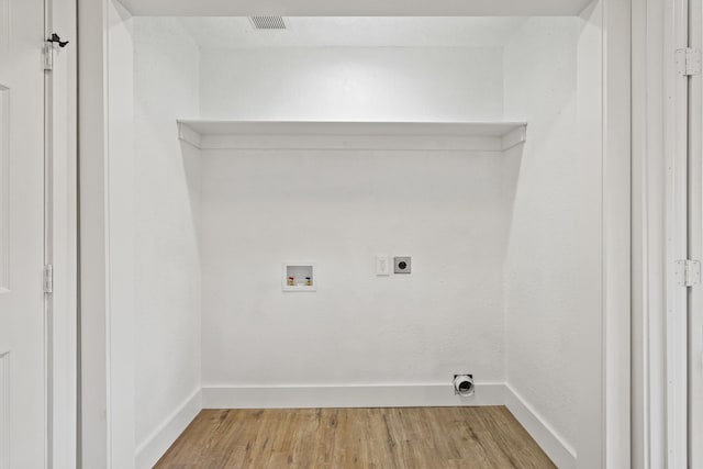 laundry area with washer hookup, light wood-style floors, electric dryer hookup, laundry area, and baseboards