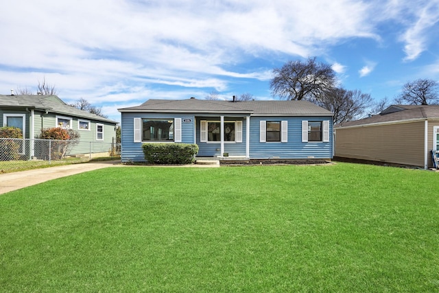 view of front of house with fence and a front lawn