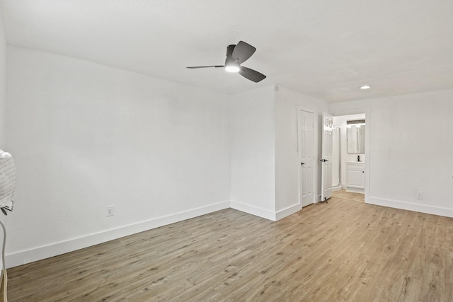 unfurnished room featuring light wood finished floors, baseboards, and a ceiling fan