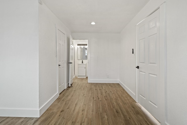 hall featuring baseboards and wood finished floors