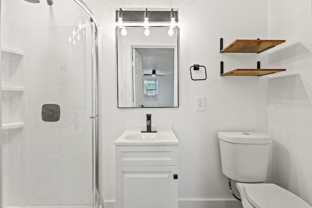 bathroom with vanity, a shower stall, and toilet