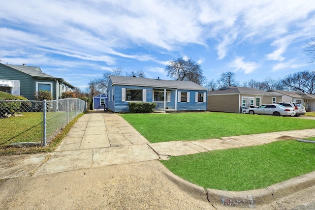 view of front of home featuring a front yard, concrete driveway, and fence