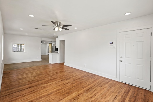 unfurnished living room with recessed lighting, visible vents, and wood finished floors