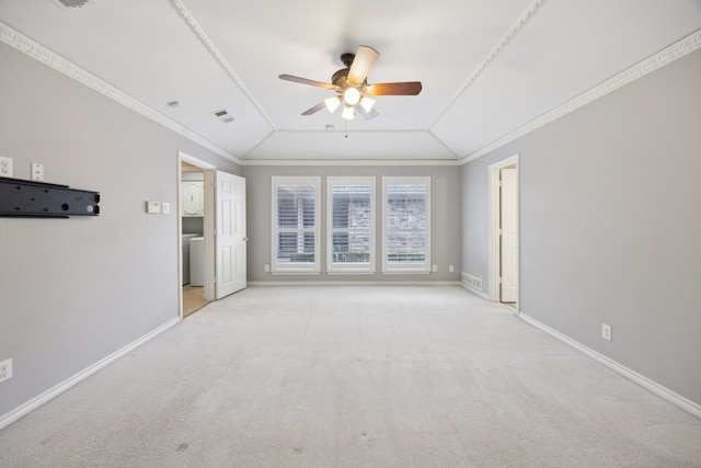 carpeted spare room featuring ornamental molding, vaulted ceiling, and baseboards