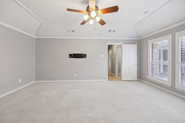 unfurnished room featuring crown molding, lofted ceiling, visible vents, light carpet, and baseboards