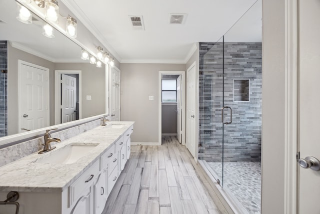 bathroom with crown molding, a stall shower, a sink, and wood tiled floor