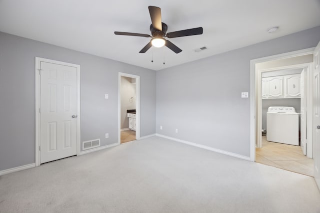 unfurnished bedroom with washer / dryer, visible vents, carpet floors, and baseboards