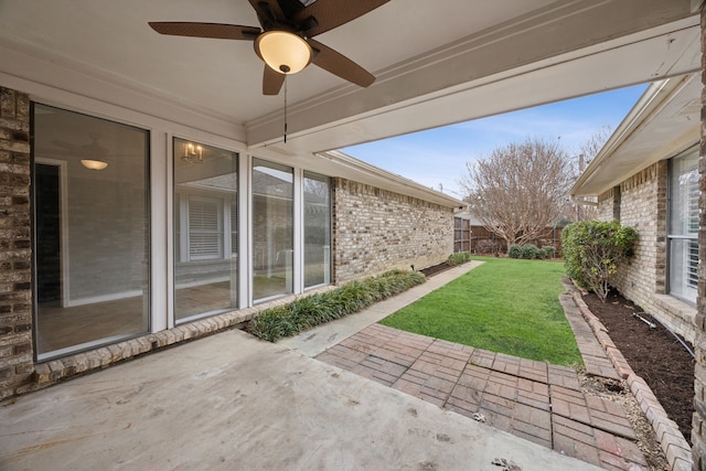 view of patio with ceiling fan and fence