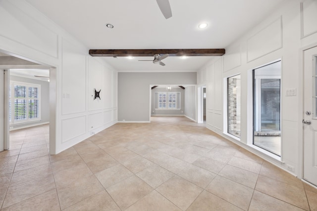 unfurnished room featuring a ceiling fan, beam ceiling, a decorative wall, and light tile patterned floors