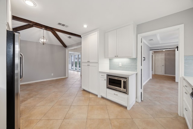 kitchen with lofted ceiling with beams, visible vents, light countertops, appliances with stainless steel finishes, and tasteful backsplash