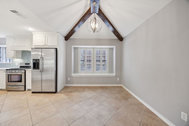 kitchen with vaulted ceiling with beams, visible vents, appliances with stainless steel finishes, white cabinetry, and light tile patterned flooring