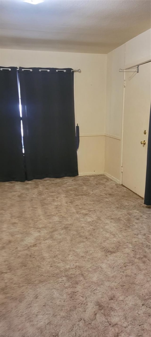 unfurnished room with carpet flooring
